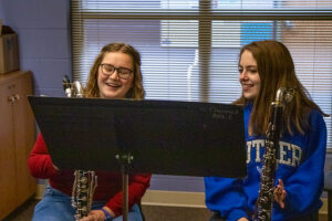 two Luther music students practicing bass clarinet