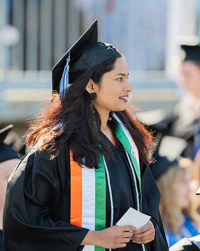 a Luther student wearing a cap and gown at commencement