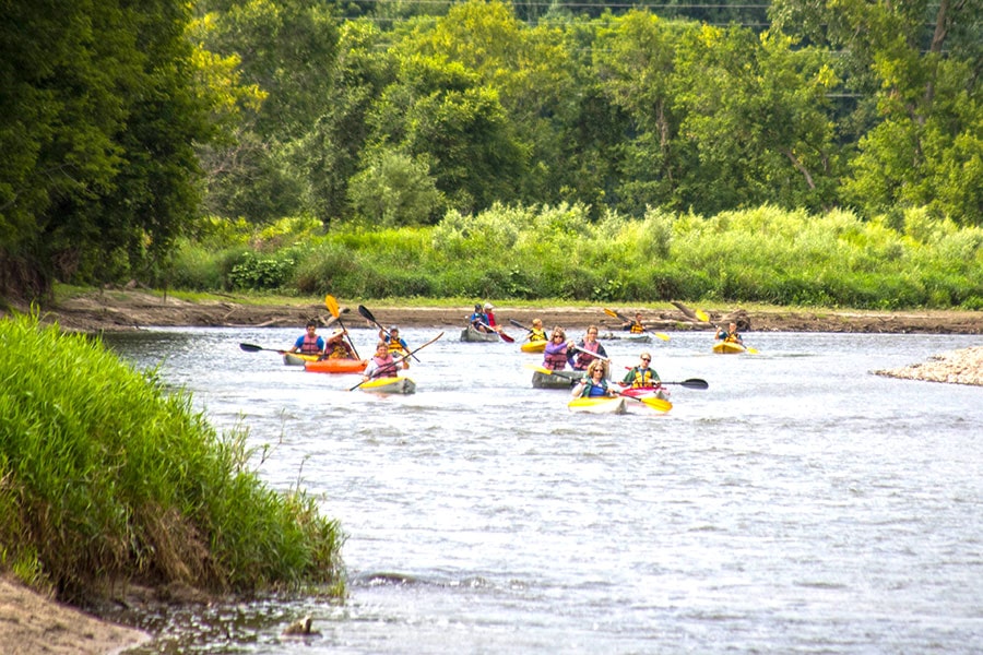 a group of people kayaking on a river