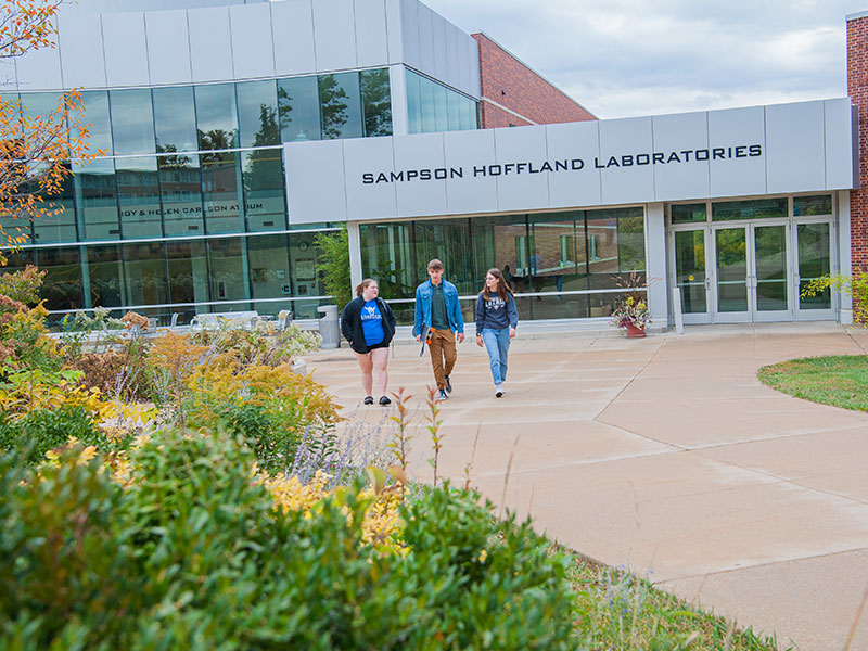 Photo of three students walking outside Sampson Hoffland Laboratories