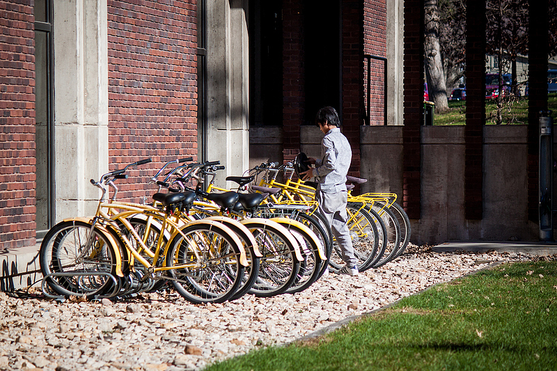 student selects one of many yellow bikes Luther College offers