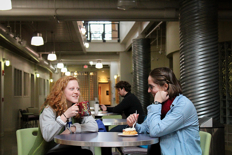 two students talk to each other in the Center for the Arts (CFA)