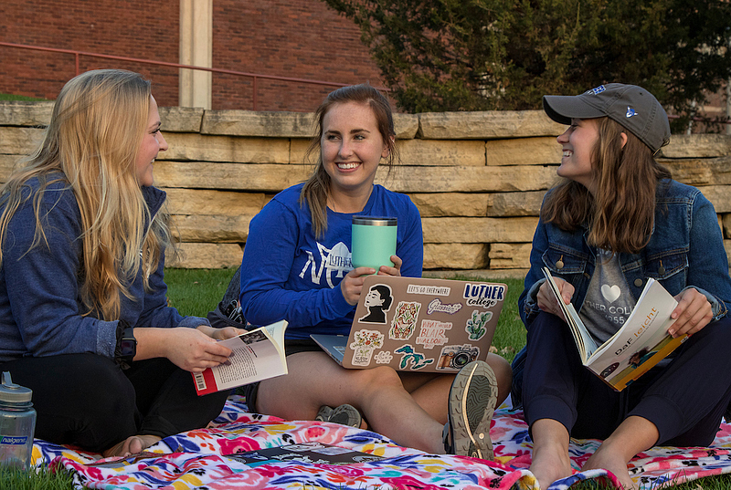 students study and chat with each other on preus library lawn